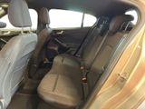 the back seats of a car with a luggage bag in the passenger seat