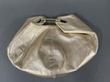 an image of a gold purse sitting on top of a table