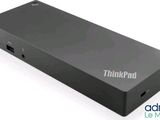 a close up of a small black device on a white surface