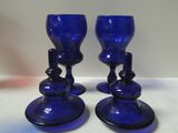 two blue glass goblets sitting on a white table