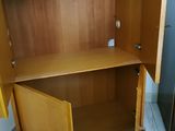 a wooden cabinet with a door open on the floor