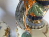 two vases that have been decorated with flowers on them