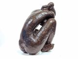 a sculpture of a woman sitting on her knees