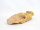 an image of a small figurine of a fish on a white surface