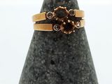 an image of a gold ring with a flower on it