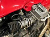 a close up of a motorcycle engine with a red cover