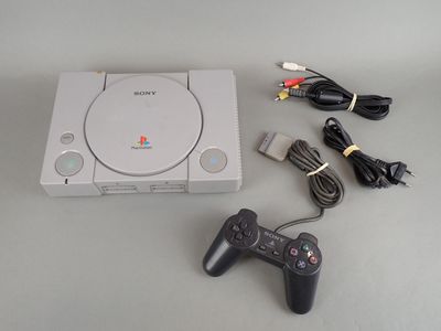 a video game console with a game controller next to it