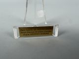 a clear glass award with a gold plaque on it