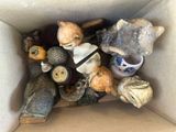 a cardboard box filled with a variety of decorative objects