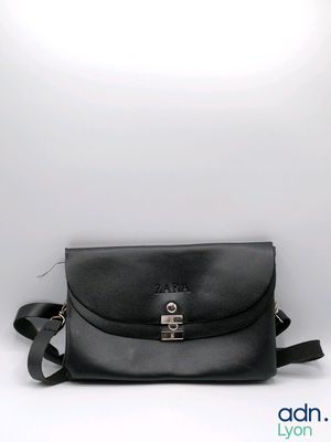 a black leather cross body bag on a white background
