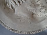 a statue of a man with a beard on a plate