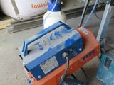 a blue and orange machine that is sitting on the ground