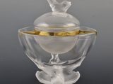 a glass bowl with a bird on top of it