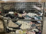 a metal cart filled with lots of trash in a warehouse