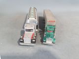 two toy trucks sitting next to each other on a table