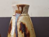 two vases that are sitting on a table