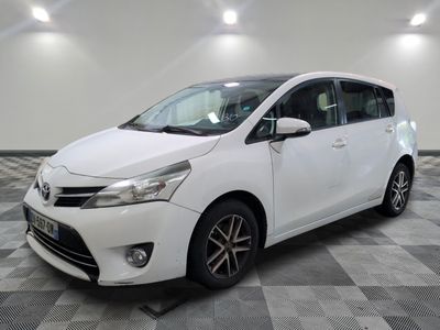 the white toyota sienna is parked on a checkered tile floor