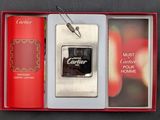 a silver lighter in a red box next to a red book