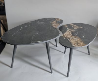 two tables that are sitting side by side on the floor