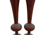 pair of red vases sitting on top of each other on a white surface