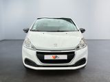the front view of a white car parked in a showroom