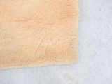 a bathroom rug on the floor next to a toilet