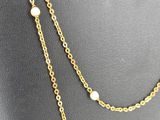 a gold chain necklace with pearls on a mannequin mannequin