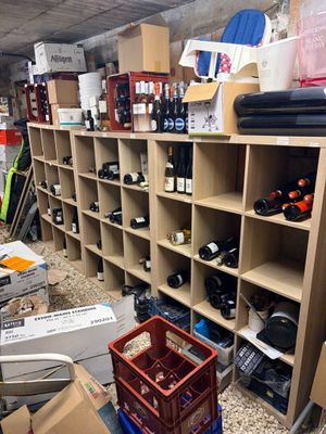a room filled with lots of wine bottles and boxes