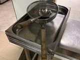 a stainless steel sink with a metal spoon on it