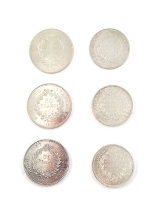 six different types of silver coins on a white surface