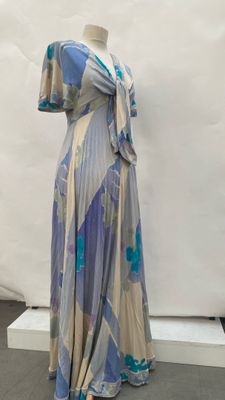 an image of a dress on a mannequin stand in front of a white backdrop