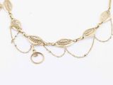 a close up of a gold necklace on a white background