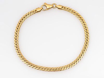 un bracelet en or jaune sur fond blanc