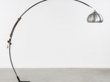 a metal floor lamp with a black base and a silver shade