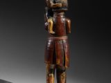 wooden statue of a man holding a child in his arms