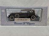 an old model car is in a box on a white surface