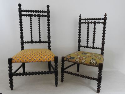 pair of antique black painted chairs with yellow upholstered cushions