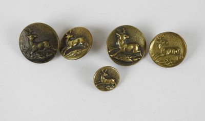 a group of four bronze buttons with animals and birds