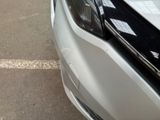 a close up of a car ' s headlight on the street