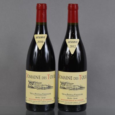 two bottles of wine sitting on top of a table next to each other