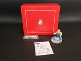 une petite figurine représentant un homme, dans une boîte rouge
