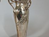 two silver vases that are sitting next to each other