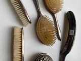 a lot of brushes and combs on the table