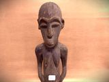 a wooden statue of a man with no shirt on