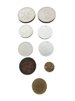 a lot of coins that are on a white surface