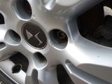 a close up of a car wheel with a logo on it