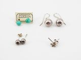three pairs of silver and turquoise earrings on a white surface