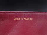 a close up of a red purse with gold lettering on it