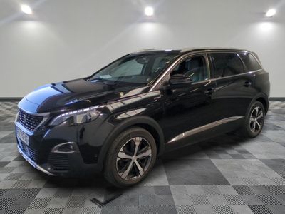 a black suv parked in a garage with a checkered floor