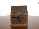 a small wooden box sitting on a table with a key in it